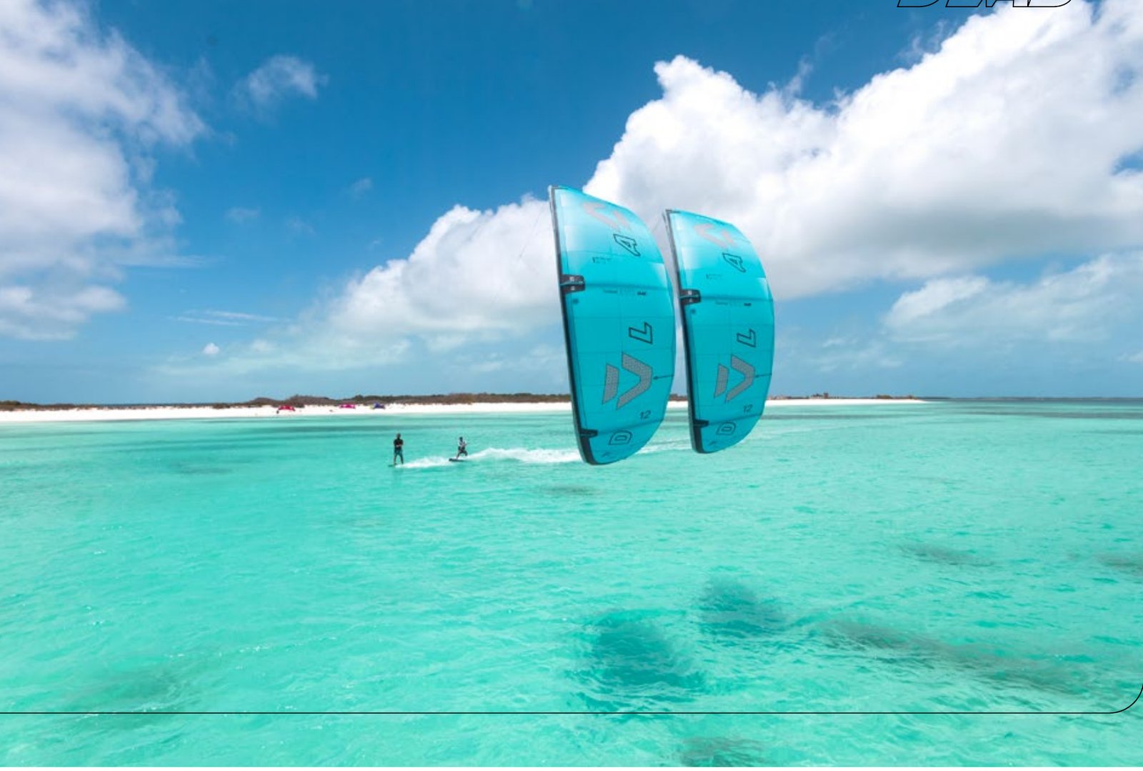 Two riders on Duotone Evo D/LAB 2027 kites over flat turquoise water