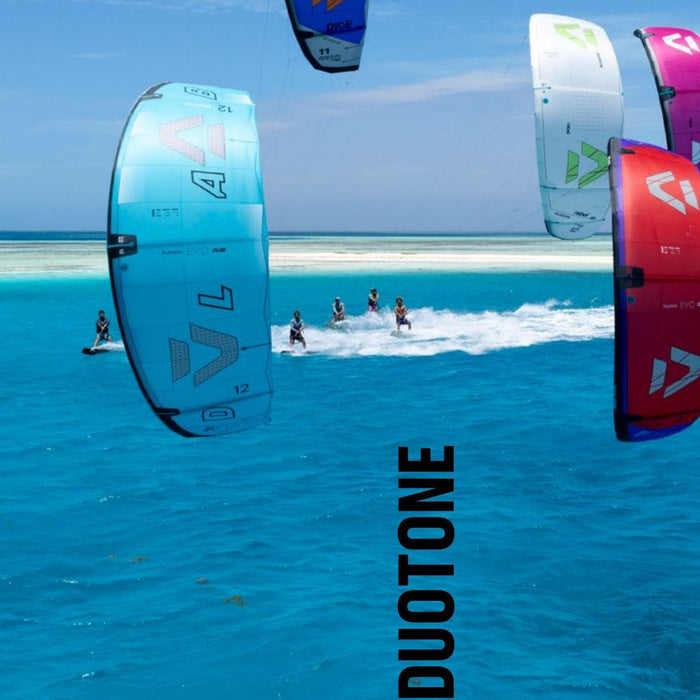 Group of 2027 Duotone kites over flat turquoise water