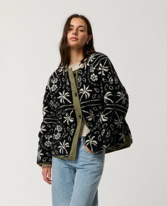 Rip Curl Bossa Nova Revo women’s reversible jacket in Military Green – angled front view of the patterned side with hand in pocket