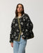Rip Curl Bossa Nova Revo women’s reversible jacket in Military Green – angled front view of the patterned side with hand in pocket