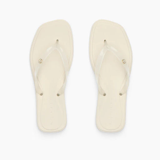 Cream flip flops with clear straps, ideal for beachwear and watersports