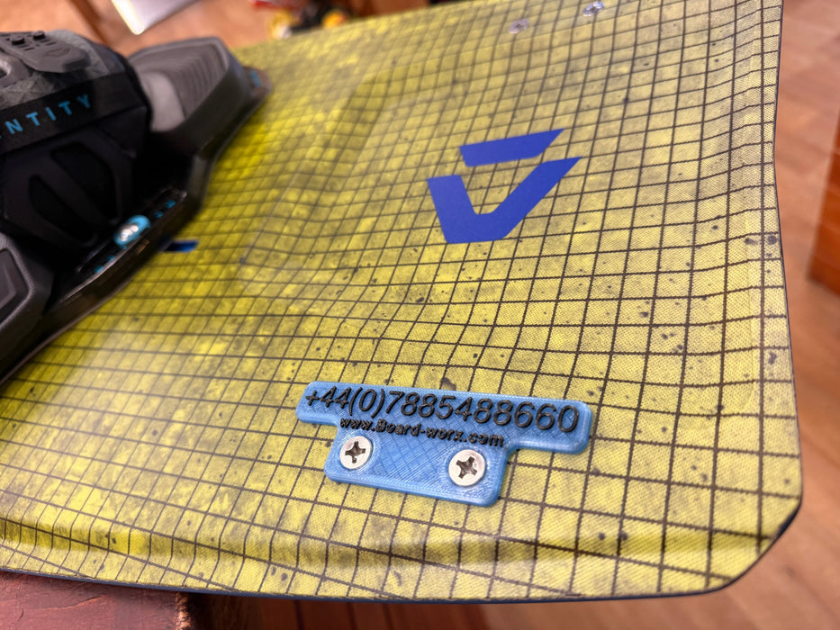 Custom kiteboard ID plate mounted on twin-tip board