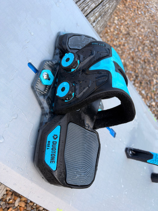 Duotone Entity 360 binding on used Jaime SLS kiteboard, close-up of dual ratchet dials