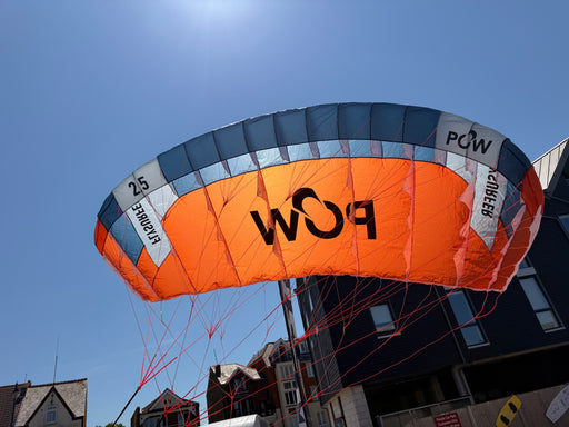 Flysurfer POW 2.5m parawing in flight against blue sky — Board-Worx