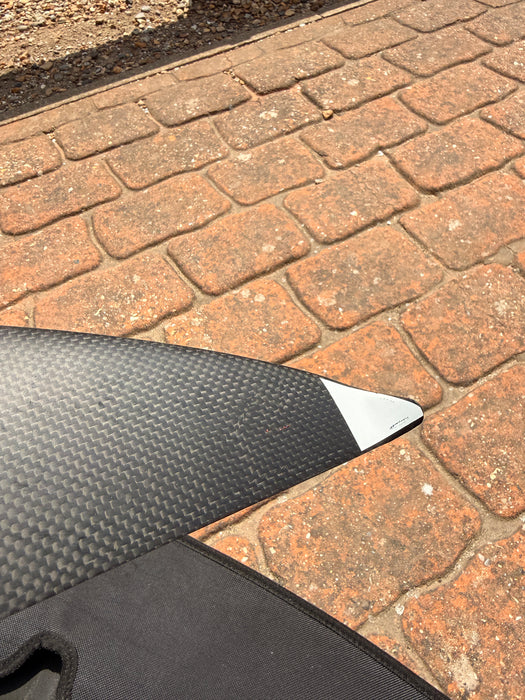 Close-up of wingtip of used F-one Eagle 990 HM Carbon showing white protective tip and slight surface scuffs — disclosed cosmetic marks