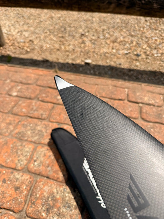 Close-up of wingtip of used F-one Eagle 990 HM Carbon showing Eagle 990 text and slight surface scuffs on leading edge — disclosed cosmetic marks