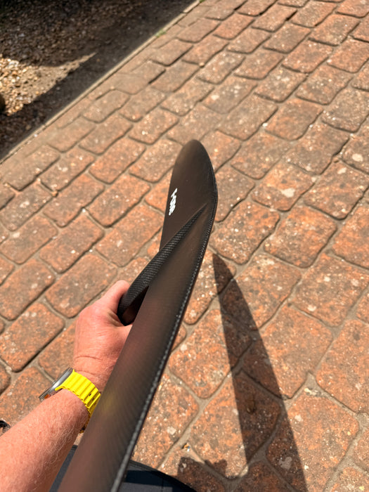 Side profile of used F-one Eagle 990 HM Carbon wingtip showing foil section and leading edge curvature