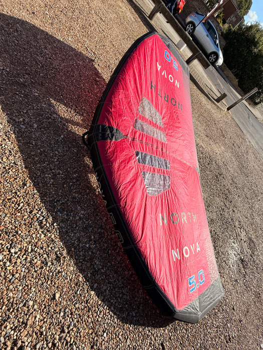 Close-up of the North Nova 5.0 wing's clear window and leading edge against the sky