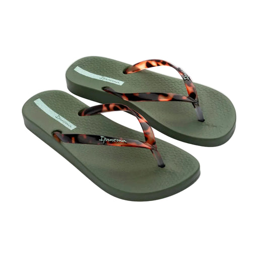 Pair of green flip-flops with tortoiseshell straps on a white background