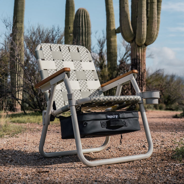 Single Parkit Voyager Dune camp chair beside saguaro cactus trees in desert landscape