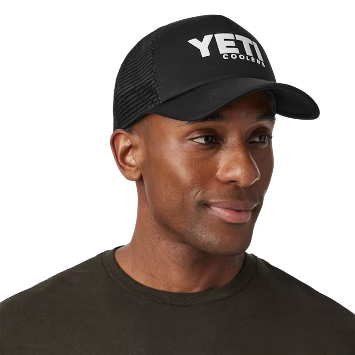 Man wearing the black Yeti Coolers Mid Pro Foam Trucker Hat