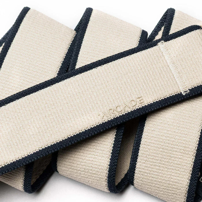 Arcade beige and navy webbing belt with navy trim, close-up texture view