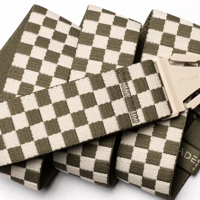 Arcade belt with khaki and cream checkered pattern and plastic buckle, close up