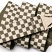 Arcade belt with khaki and cream checkered pattern and plastic buckle, close up