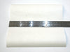 Clear kitesurfing bladder repair patch 20x20cm with metal ruler on white background