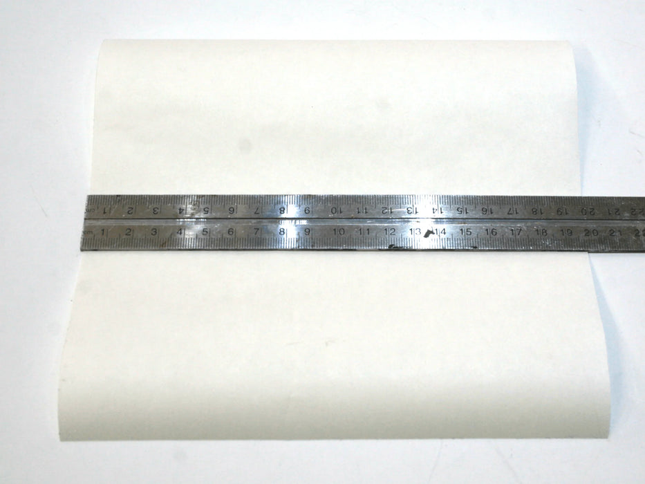 Clear kitesurfing bladder repair patch 20x20cm with metal ruler on white background