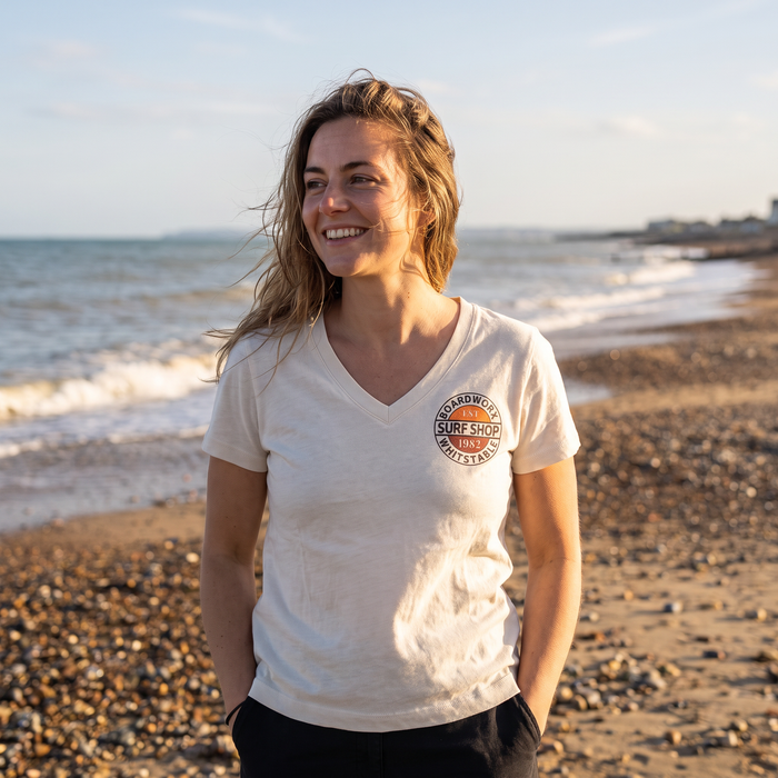 Woman wearing Boardworx Surf Shop Natural Raw V-neck T-shirt on Whitstable beach, front view