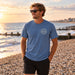 Man wearing the Boardworx Surf Shop indigo blue T-shirt on a Whitstable shingle beach, front view