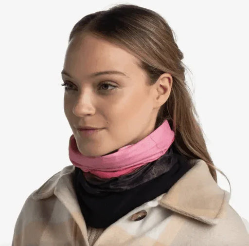 Pink and black neck gaiter for watersports, worn with beige coat, ideal for Whitstable surf & paddleboard adventures