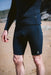 C-Skins black thermal wetsuit under shorts for watersports on sandy beach