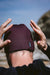 c-skins 2mm neoprene beanie in rust, worn outdoors, ideal for watersports