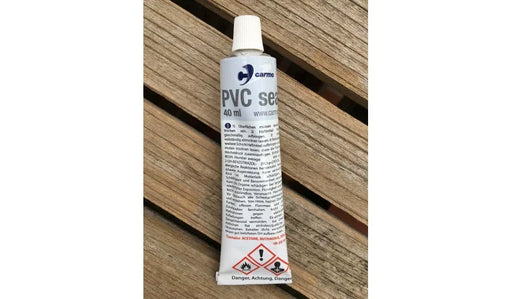 Carmo PVC seal glue 40ml tube for kite bladder repair, white tube on wooden surface