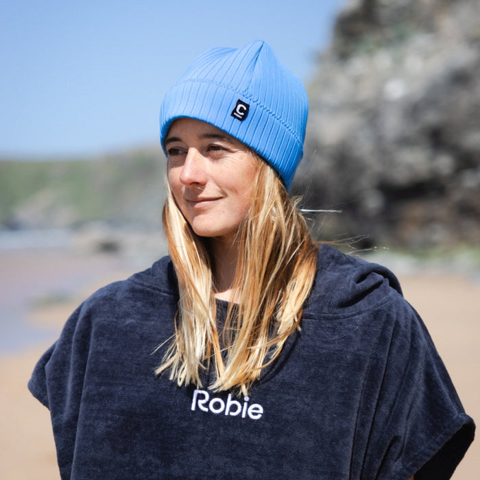 C-Skins Storm Chaser Cobalt Blue neoprene beanie worn at the beach