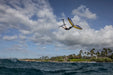 Duotone foil mast and wing in use over ocean, rider airborne with blue and yellow wing foil