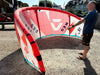 Duotone Neo 2024 10m red kitesurfing kite being inspected outdoors