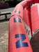 Duotone Neo 2024 10m red kitesurfing kite leading edge with bold blue lettering outdoors