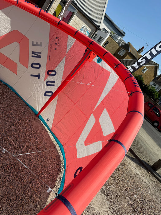 Duotone Neo 2024 kitesurfing kite, 10m size, red and white, used, displayed outdoors