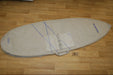 Duotone 6ft beige surfboard bag with blue accents on wooden floor