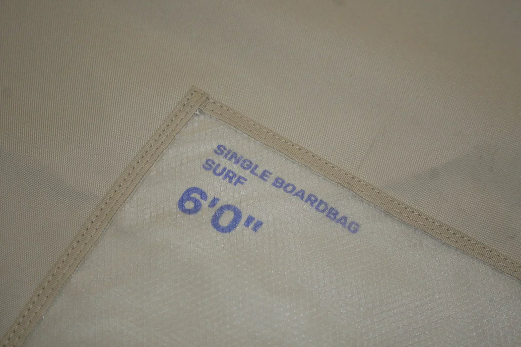 Tan surfboard bag with blue 'Single Boardbag Surf 6'0'' text, durable fabric detail
