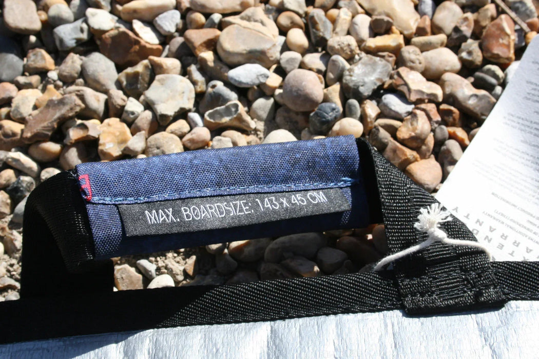 Duotone blue and black single twin tip board bag handle, max board size 143x45cm, on pebbles