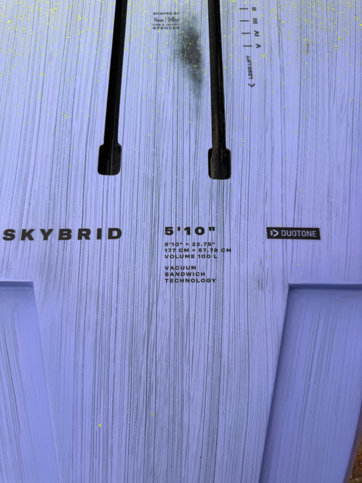 Close-up of specs label on used Duotone Skybrid 5'10" 100L 2025 showing 177cm x 57.78cm dimensions and Vacuum Sandwich Technology