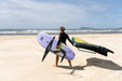 A rider using the Duotone Mid Length Wing Foil board to catch a wave, demonstrating its high-performance glide and light wind efficiency.