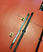 Duotone wing foil track nuts and sled on an orange board, close-up hardware view