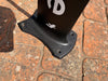 Top view of used F-one Carbon Mast 85 board foot connection showing F-one lightning bolt logo and 3-hole plate fitting