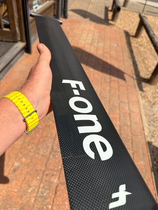 Close-up of F-one Carbon Mast 85 body showing F-one branding and carbon weave construction