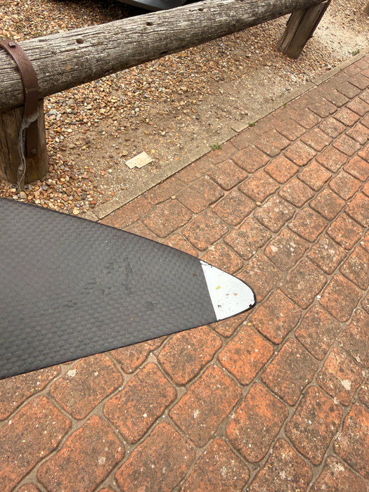 Overhead close-up of right wingtip of used F-one Eagle 1290 HM Carbon showing white tip protector and carbon weave surface