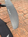 Close-up of wingtip of used F-one Sk8 V2 850 wing foil front wing showing surface scuffs on carbon — disclosed cosmetic marks, no structural damage