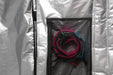 Mid-length down wind travel bag interior with mesh pocket and rolled pink-blue strap