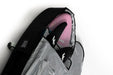 Mid-length black travel board bag with pink surfboard and black fins inside, silver lining visible