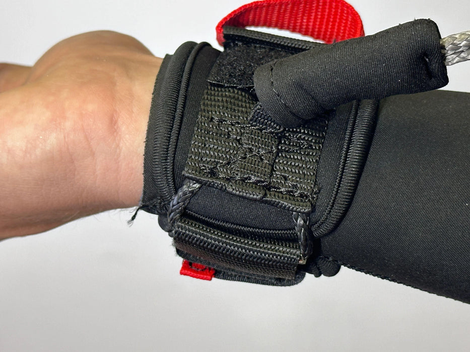 Black wing wrist leash with red pull tab for wing foiling shown on wrist