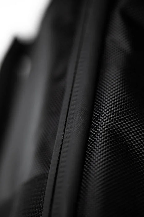 Black textured wing board bag detail with close-up of durable zip and fabric