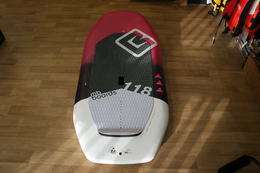 mb Boards Albatros 118L wing foil board, black and pink deck, indoor display