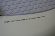 Close-up of grey wingfoil board with textured deck pad, 118L volume, 177cm length, 79.4cm width.