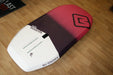 MB Boards Albatros 118L wing foil board in white and gradient purple-pink, on wood floor