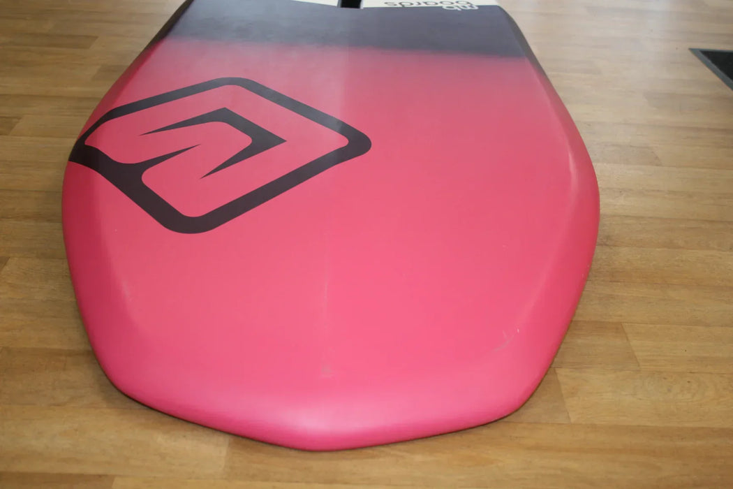 Albatros 118L wingfoil board with pink and black design on wooden floor