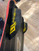 Naish Monarch kitesurfing board black fins with yellow logo and wood pattern on base